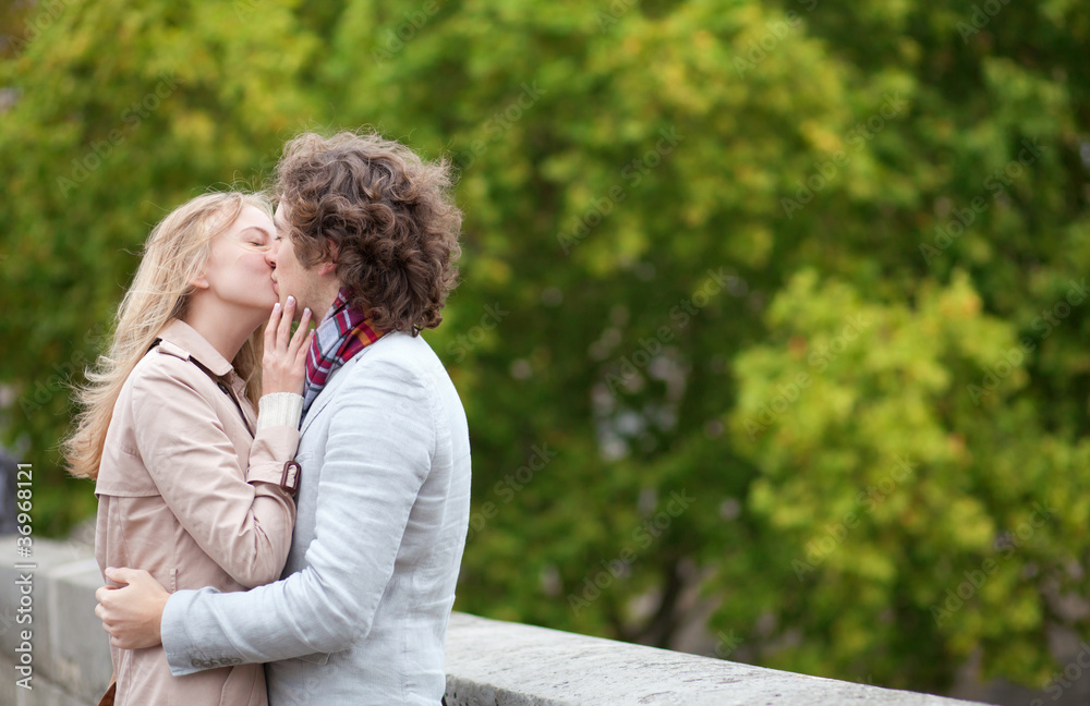 Fototapeta premium Romantic couple kissing outdoors