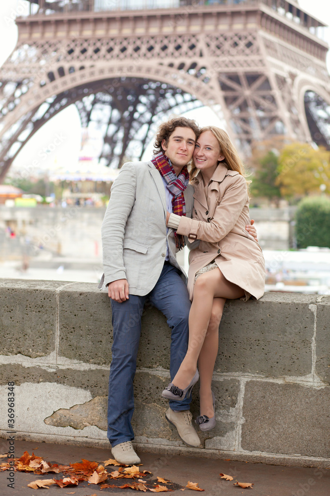 Fototapeta premium Beautiful romantic couple in Paris near the Eiffel Tower