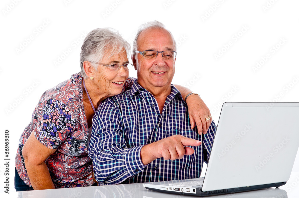 Seniors couple using a computer laptop Seniors couple using a computer laptop