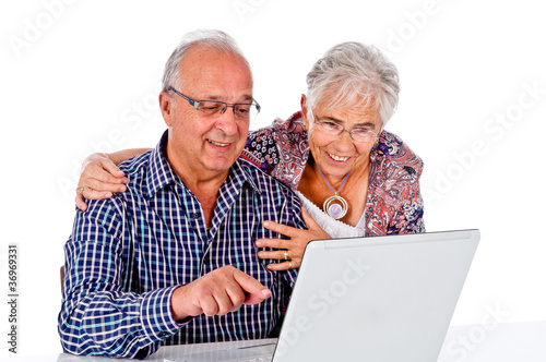 Seniors couple using a computer laptop