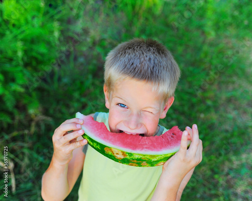 Young boy eating watermelon