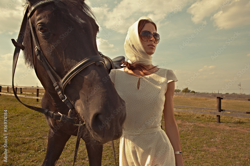 Fototapeta premium beautiful girl in a white gown with horse on nature