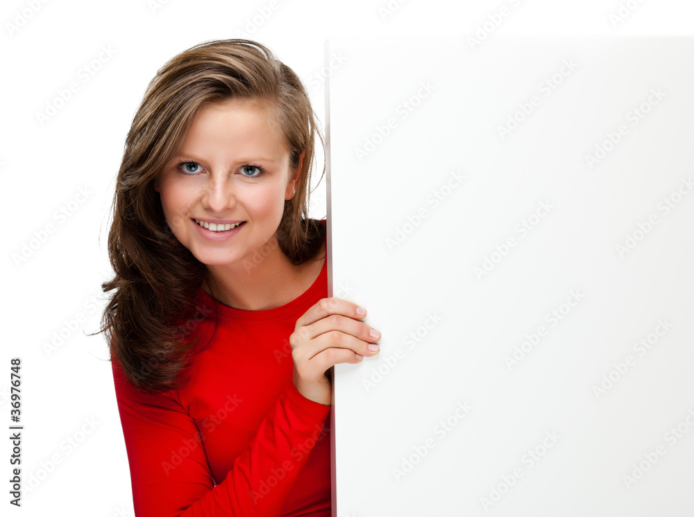 Young attractive girl behind empty board on white background Young attractive girl behind empty board on white background