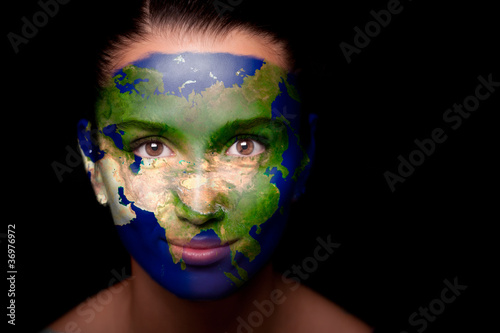 Girl with a painted map of Asia on his face.