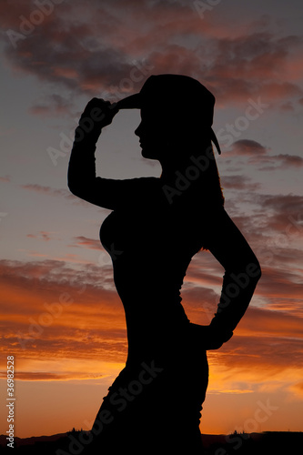 woman in sunset cowgirl stand