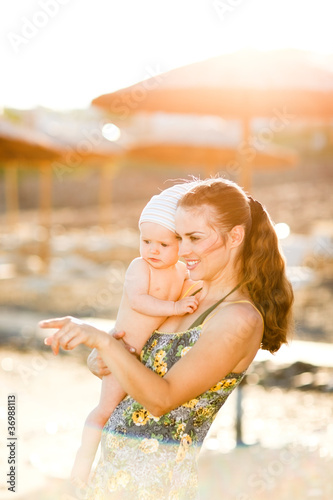 Portrait of young mother with baby on beach
