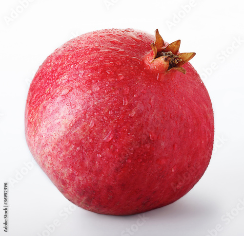 Pomegranate with water drops isolated on a white background
