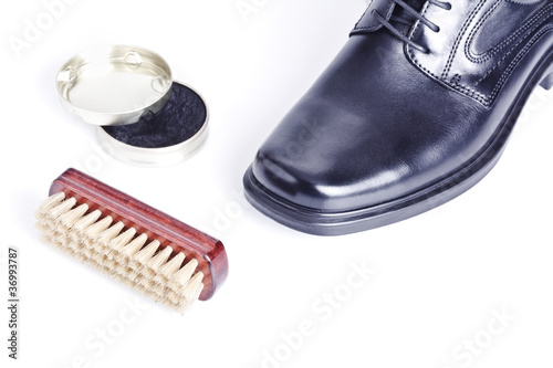 Classic black men's shoe, boot polish and brush