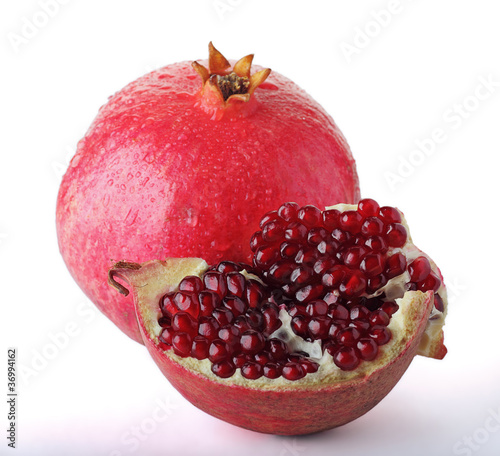 Juicy pomegranate and its half. Isolated on a white background