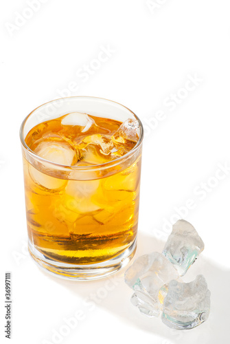 Whiskey with ice cubes. Isolated on white