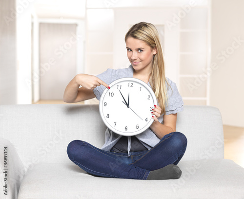 it's 5 before 12 - young woman pointing on clock / time