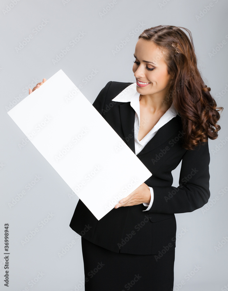 Businesswoman showing signboard, over grey Businesswoman showing signboard, over grey