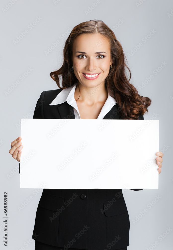 Businesswoman showing signboard, over grey Businesswoman showing signboard, over grey