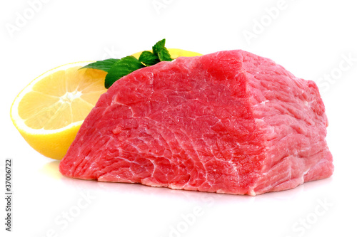 Cut of beef steak with lemon slice. Isolated.