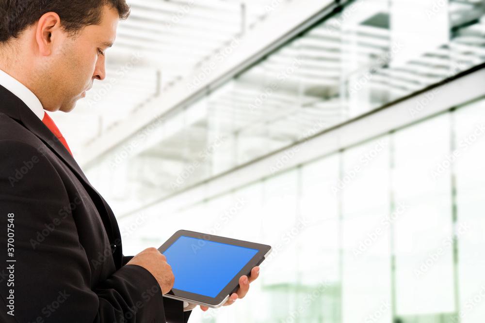 Businessman at the office using a tablet pc Businessman at the office using a tablet pc