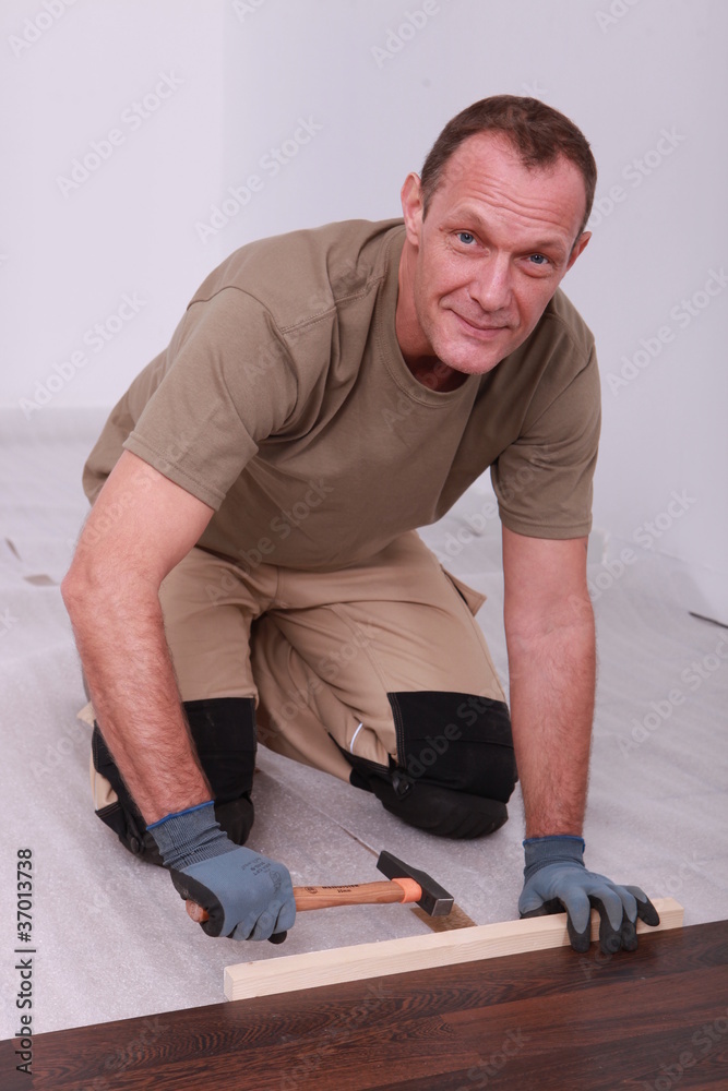 Man fitting laminate flooring Man fitting laminate flooring