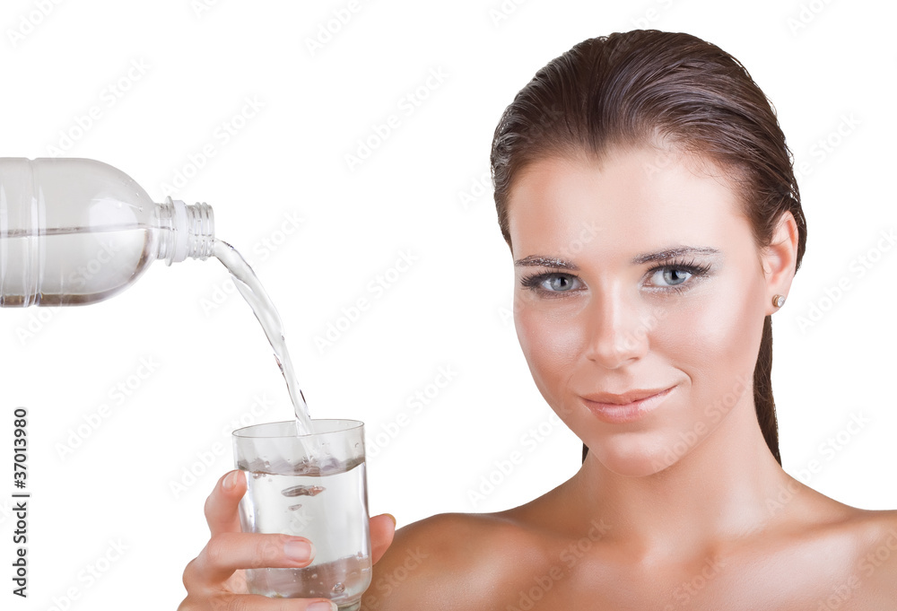 Beautiful woman holding a glass in which the water pours Beautiful woman holding a glass in which the water pours