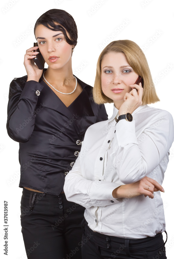 Two business women talking on mobile phone Two business women talking on mobile phone