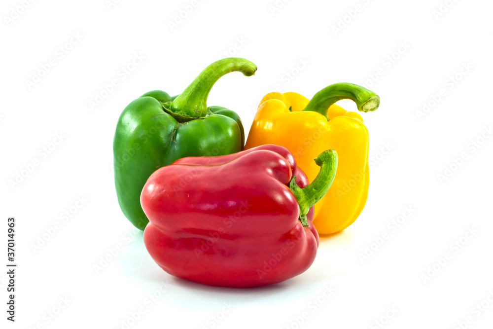 Red, yellow and green bell peppers isolated on the white backgro Red, yellow and green bell peppers isolated on the white backgro