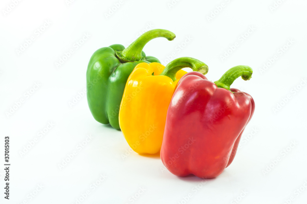 Red, yellow and green bell peppers isolated on the white backgro Red, yellow and green bell peppers isolated on the white backgro