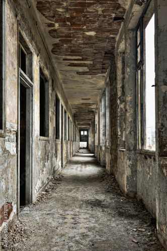 Long empty corridor and doors in abandoned building © tobago77