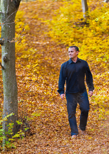 Man who was walking through the woods in autumn