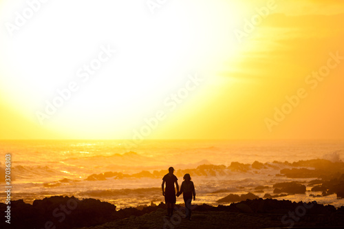 Couple walking on the beach © pwollinga