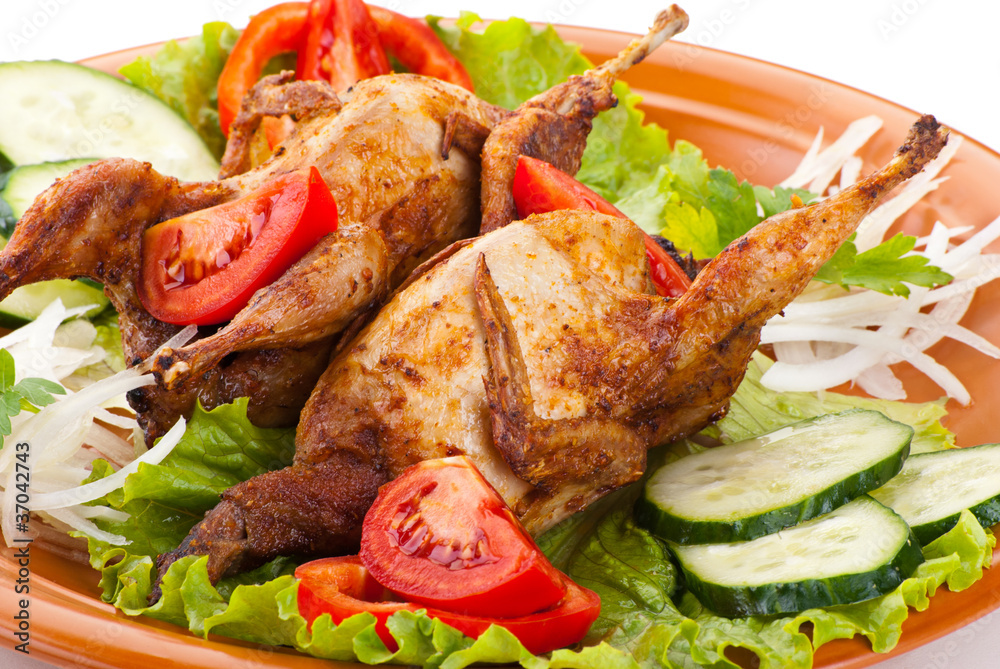 Two whole quail with cucumber, tomatoes and onion Two whole quail with cucumber, tomatoes and onion