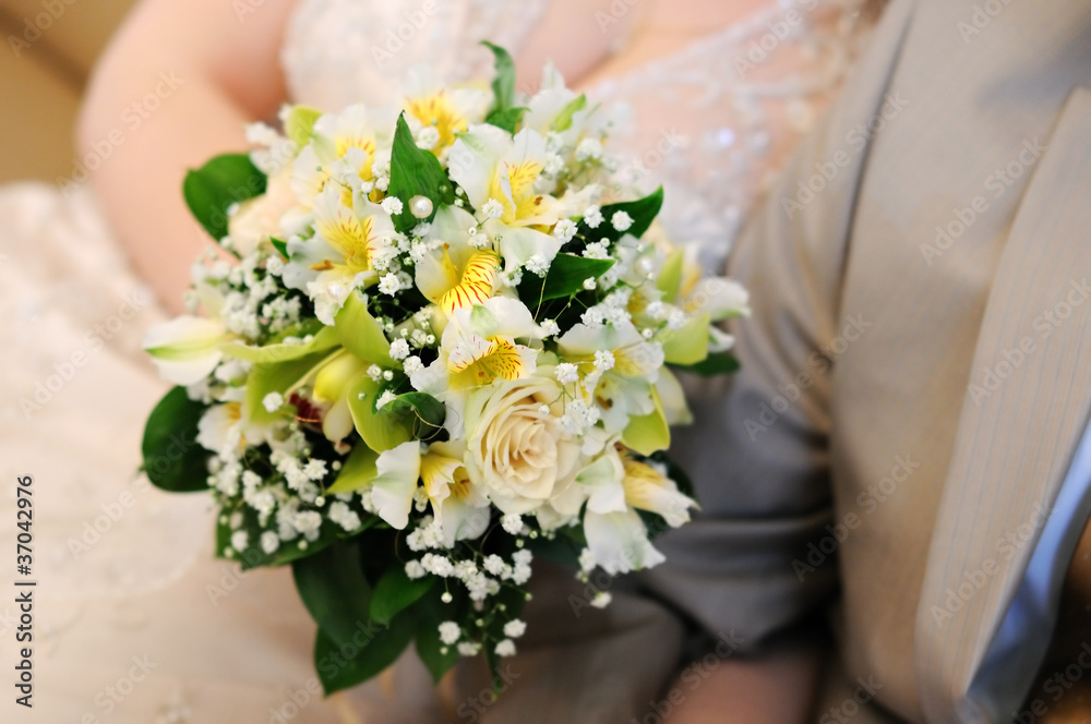 Bride holding beautiful yellow wedding flowers bouquet Bride holding beautiful yellow wedding flowers bouquet