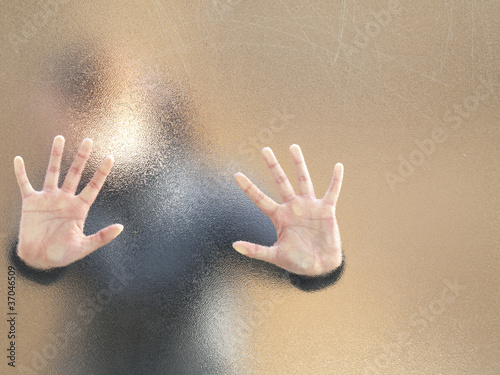 Silhouette of a girl through frosted glass