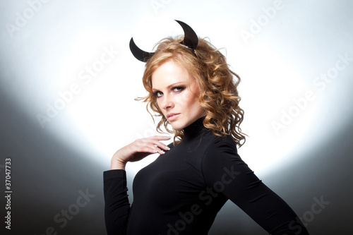 Fotografie The beautiful young girl a devil