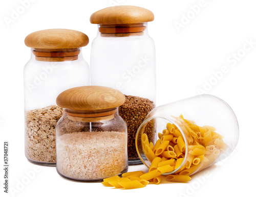 Jars with macaroni, rice, buckwheat and oatmeal isolated on whit