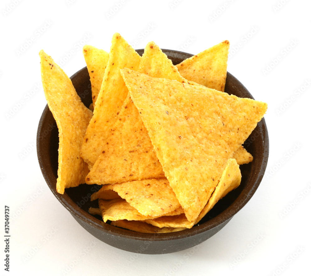 Mexican tortilla chips in brown bowl on white background Mexican tortilla chips in brown bowl on white background