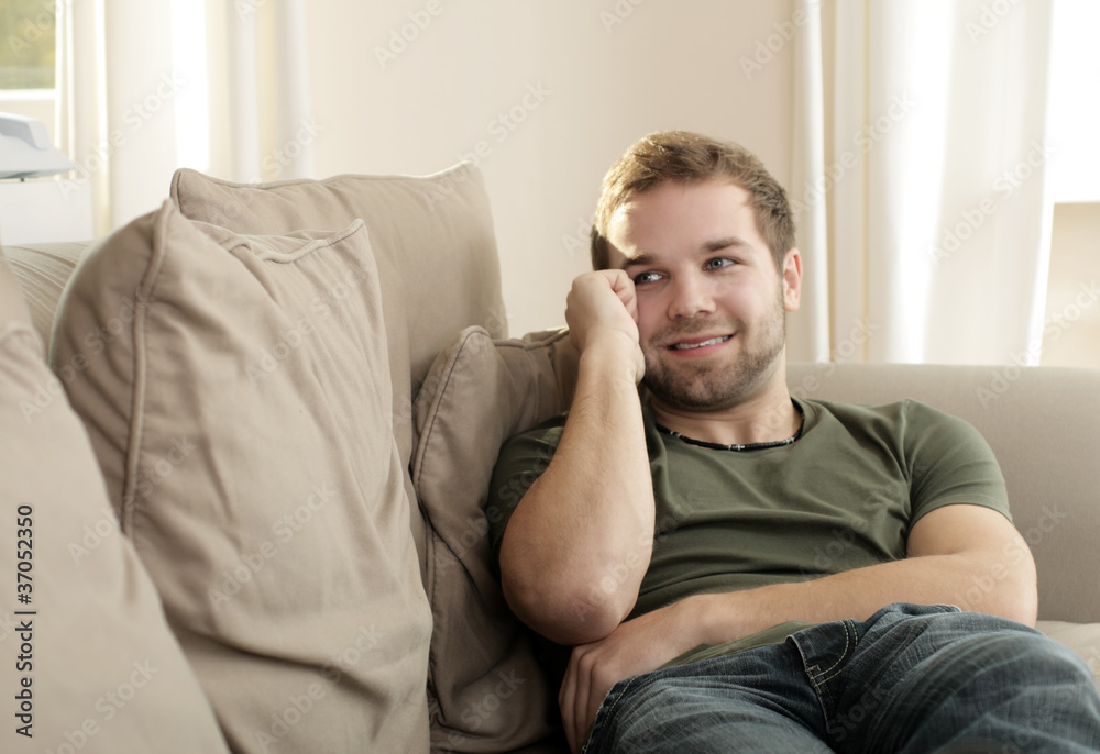 A young man relaxing on couch A young man relaxing on couch