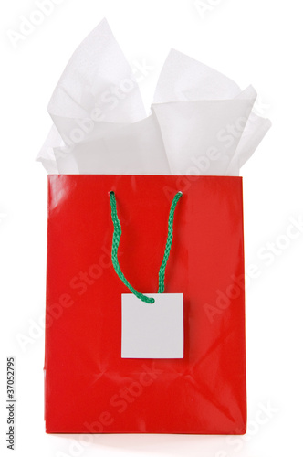Red gift bag with blank tag isolated on white
