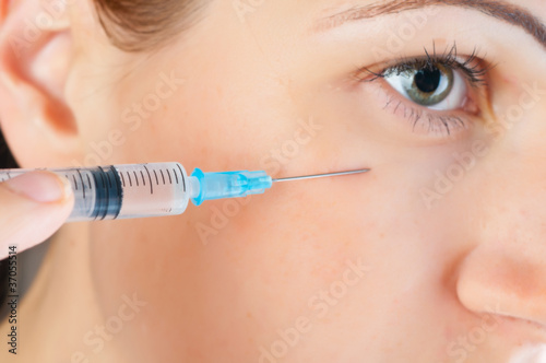 cosmetic injection of botox to the face of beautiful woman