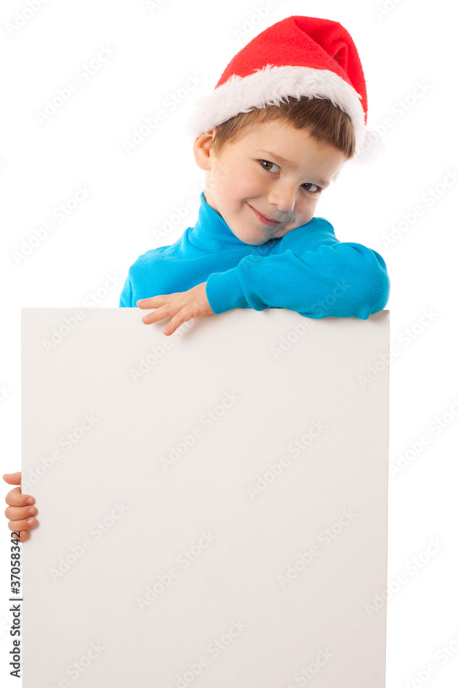 Smiling boy in Santa hat with empty banner Smiling boy in Santa hat with empty banner