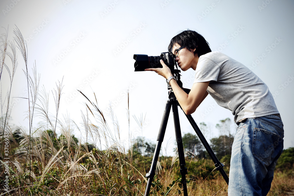 photographer taking photo in country side