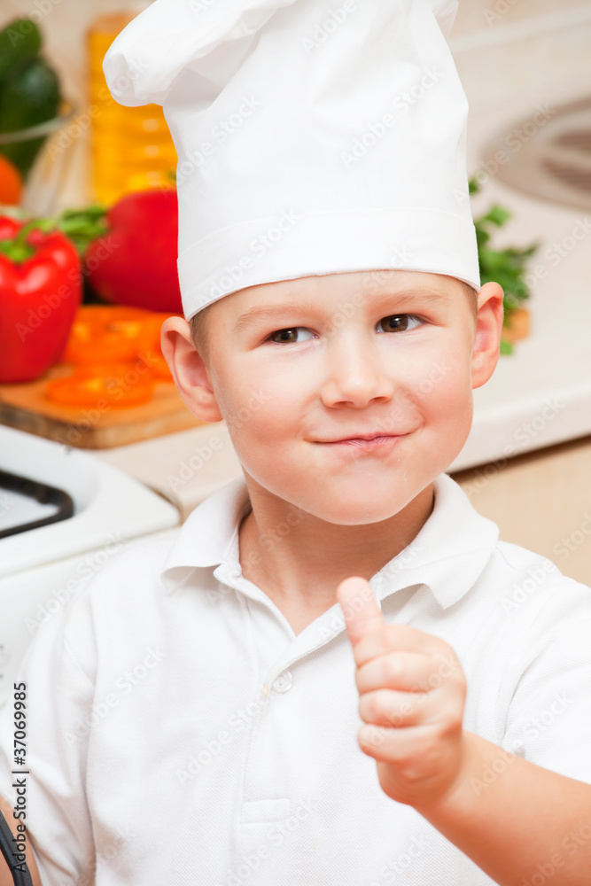little boy on kitchen helps to make a dinner little boy on kitchen helps to make a dinner