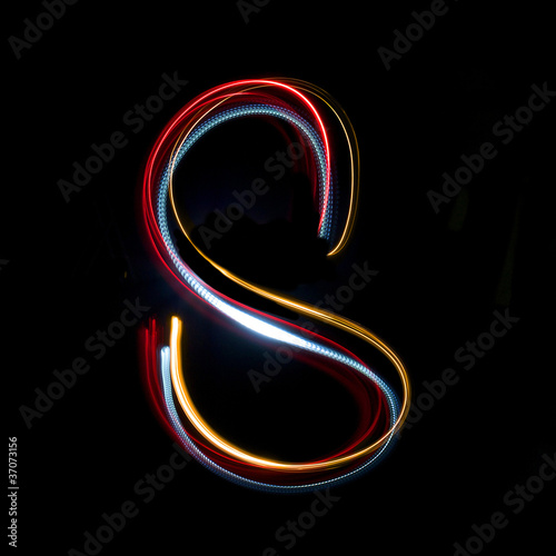 Letter s made from brightly coloured neon lights