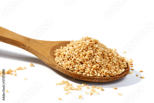 Sesame grains in large wooden spoon photo