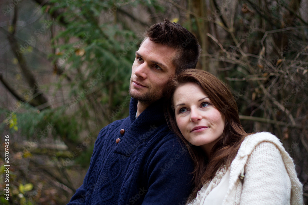 Young couple in the forest head on head