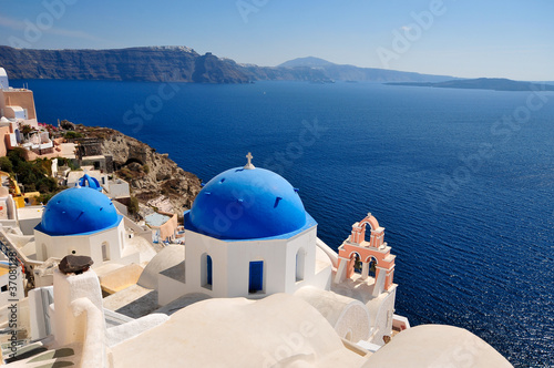 Two blue domes and their bell tower in Oia - Santorini - Greece