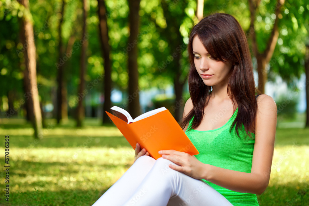 woman reading book at park woman reading book at park