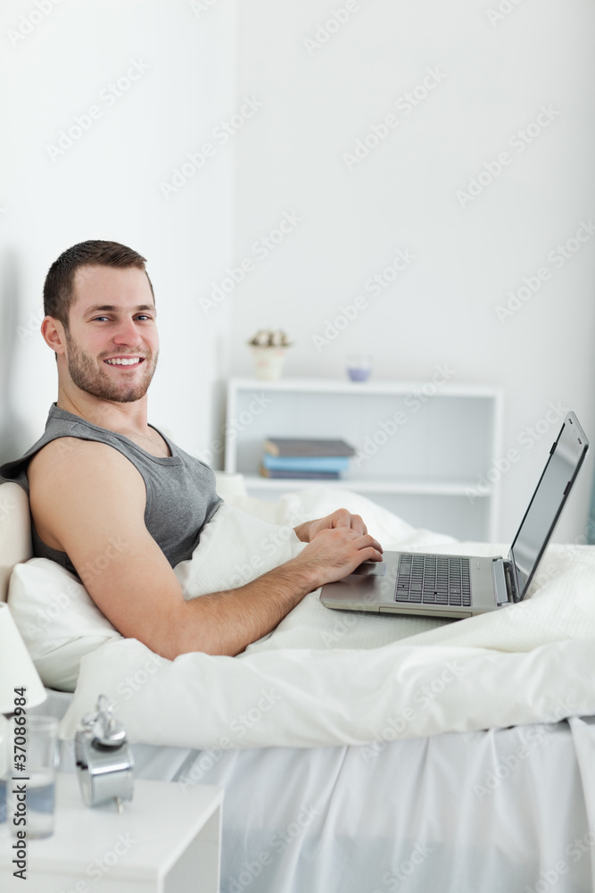 Portrait of a smiling man using a laptop Portrait of a smiling man using a laptop