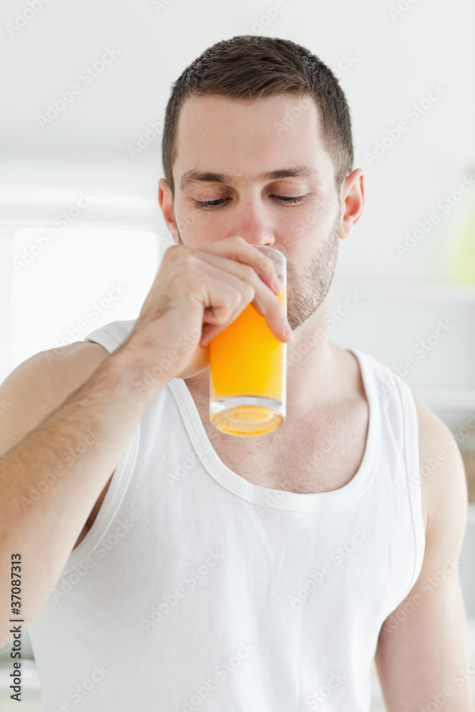 Portrait of an attractive man drinking orange juice