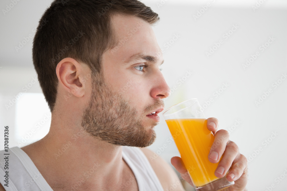 Close up of a healthy man drinking orange juice Close up of a healthy man drinking orange juice