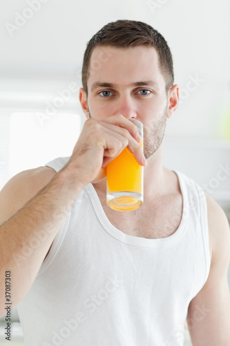 Portrait of a serene man drinking orange juice