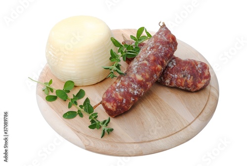 Italian salami and cheese on wooden cutting board photo