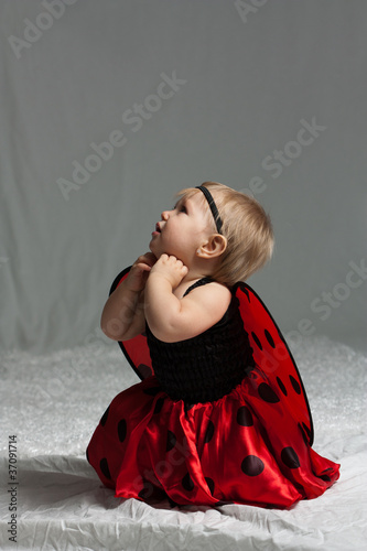 Baby Girl Dressed Up as Lady Bug Kneeling